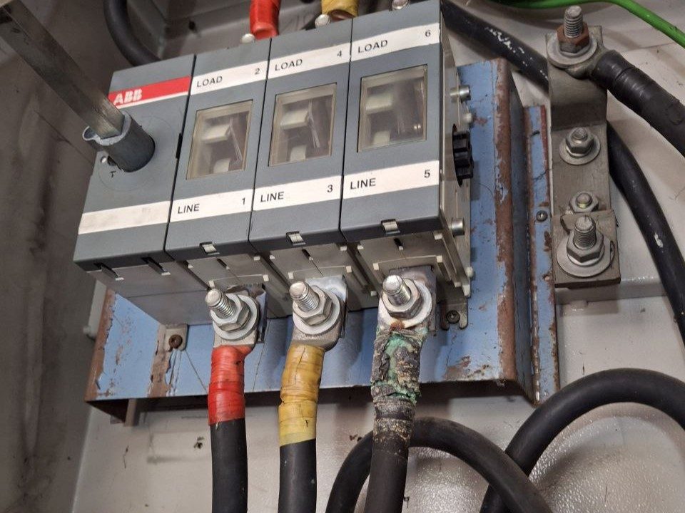 Visual photo of the same compressor isolator showing a deteriorated terminal connection